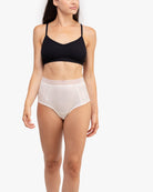 Model Wearing Uwila Warrior HIgh-Waist Silk Briefs Underwear in Winter White on White Background