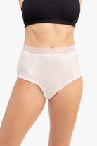 Model Wearing Uwila Warrior HIgh-Waist Silk Briefs Underwear in Winter White on White Background