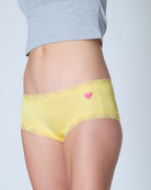 


Lemon Zest Soft Silk Brief  with lace trim and a pink heart on a plain background