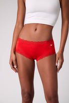 Model wearing Uwila Warrior Soft Silk Briefs with Orange Embroidered patch.