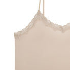 A smoke grey silk blend slip with adjustable spaghetti straps and lace trim at the neckline.