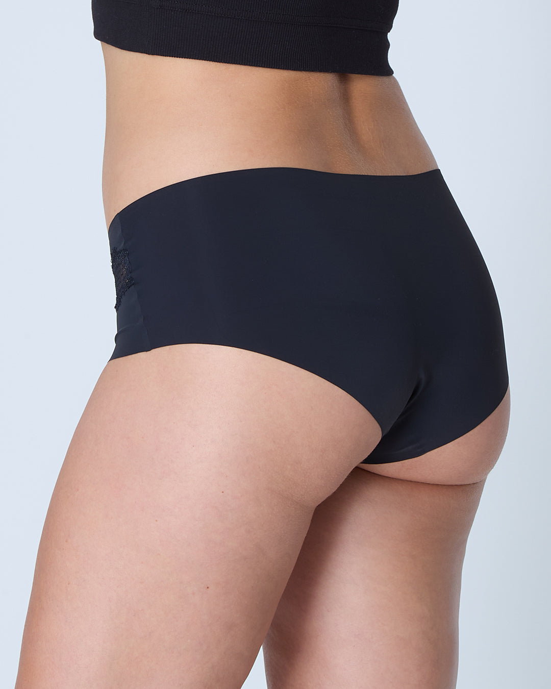 woman wearing Tap Shoe Black soft seamless briefs with lace on white background.
