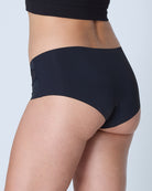 woman wearing Tap Shoe Black soft seamless briefs with lace on white background.
