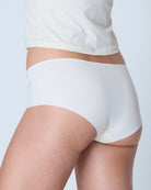 White underwear worn by a person on a light gray background