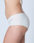 White underwear with lace trim on a plain background