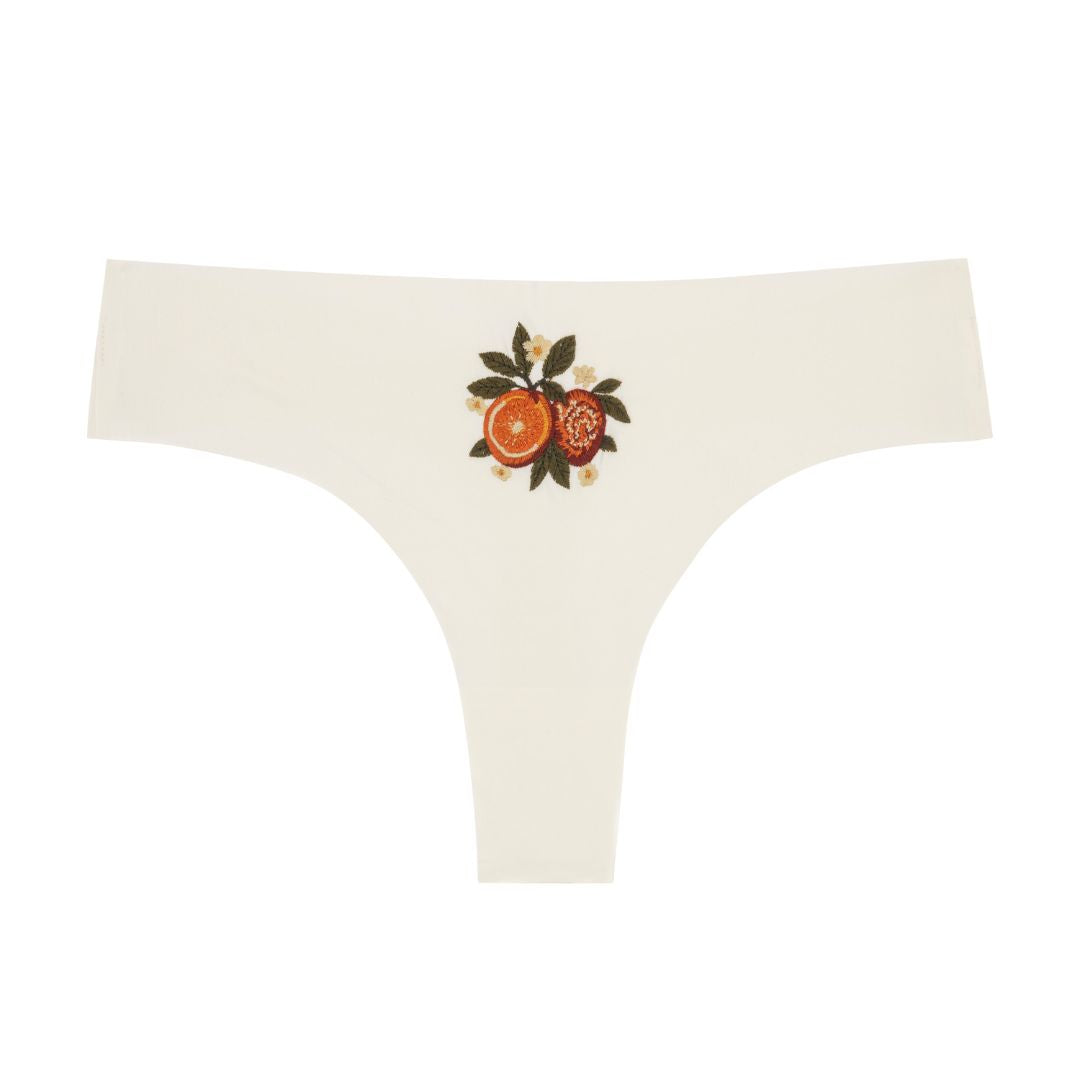 Winter White Soft Seamless Thong with orange embroidery on white background