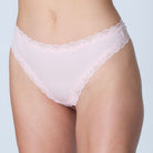 Model wearing Uwila Warrior Soft Silks Thong Underwear in Rose Quartz on White Background