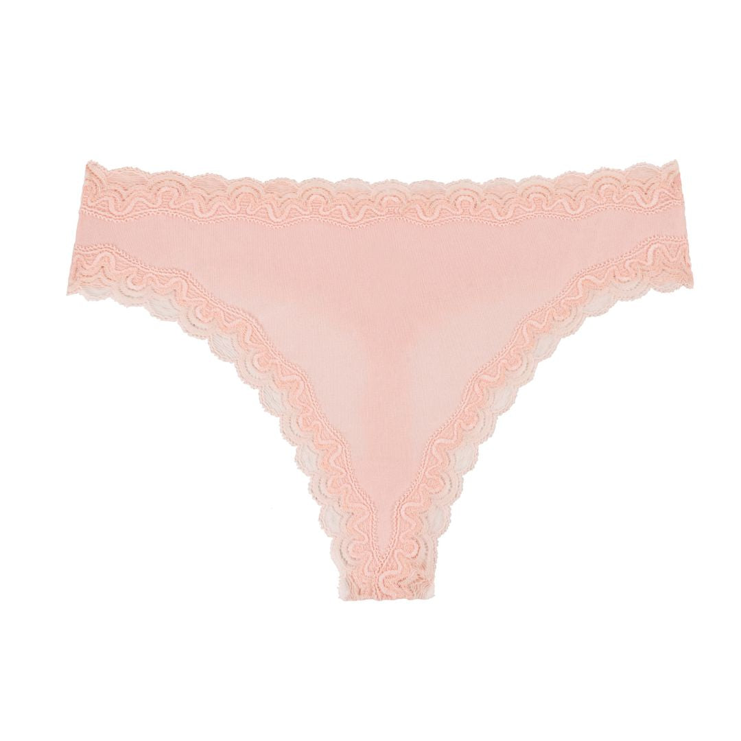 Still life of Uwila Warrior Soft Silks Thong Underwear in Rose Quartz on White Background