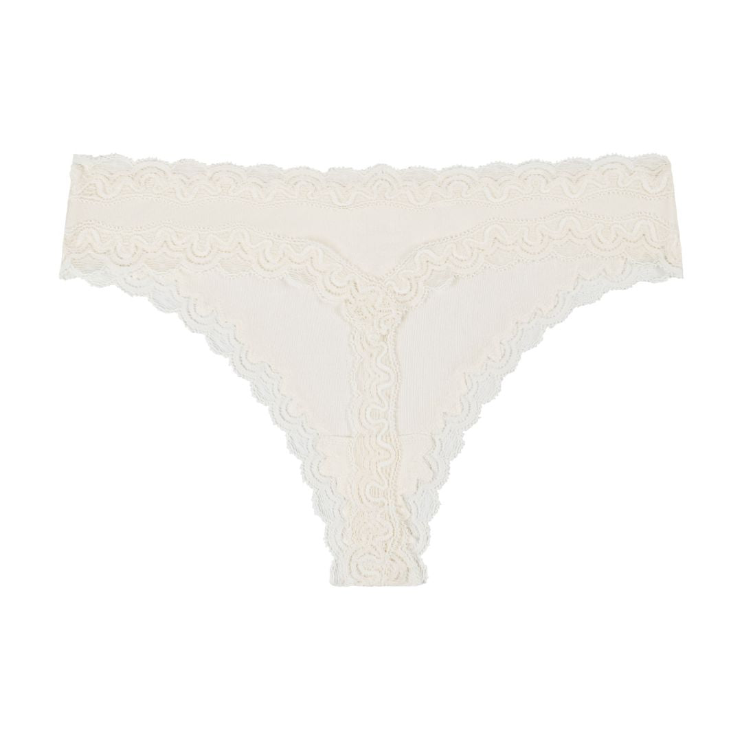 Still life of Uwila Warrior Soft Silks Thong Underwear in Winter White on White Background