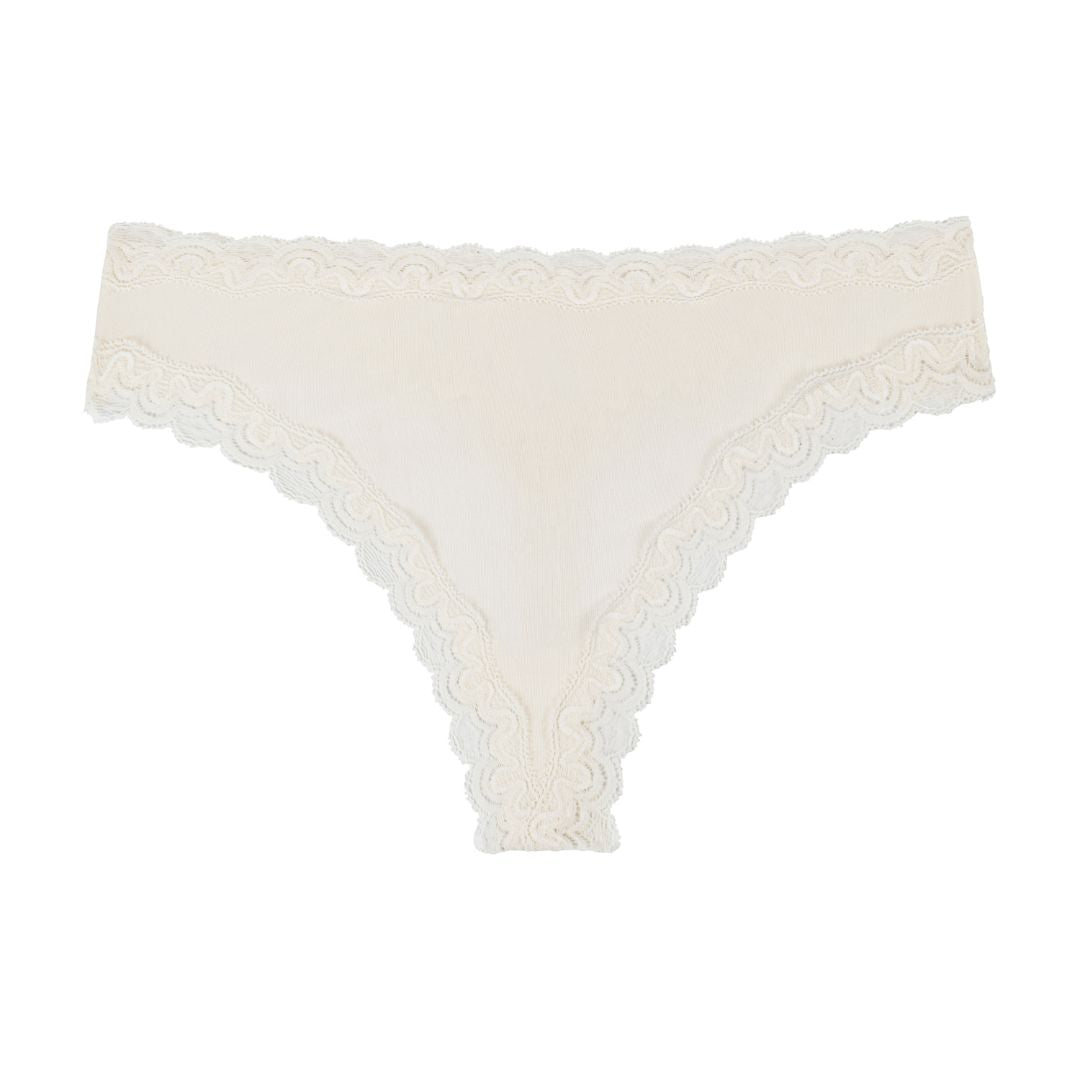 Still life of Uwila Warrior Soft Silks Thong Underwear in Winter White on White Background