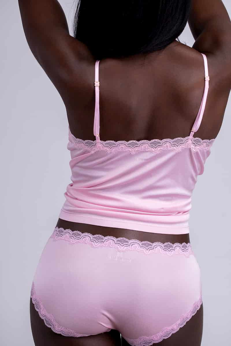 Model wearing Uwila Warrior Soft Silks Camisole in Almond Blossom on White Background