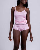Model wearing Uwila Warrior Soft Silks Camisole in Almond Blossom on White Background