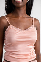 Model wearing Uwila Warrior Soft Silks Camisole in Mellow Rose on White Background