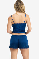 Model wearing Uwila Warrior Soft Silk Sleep Short in Estate Blue on White Background