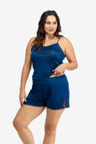 Model wearing Uwila Warrior Soft Silk Sleep Short in Estate Blue on White Background