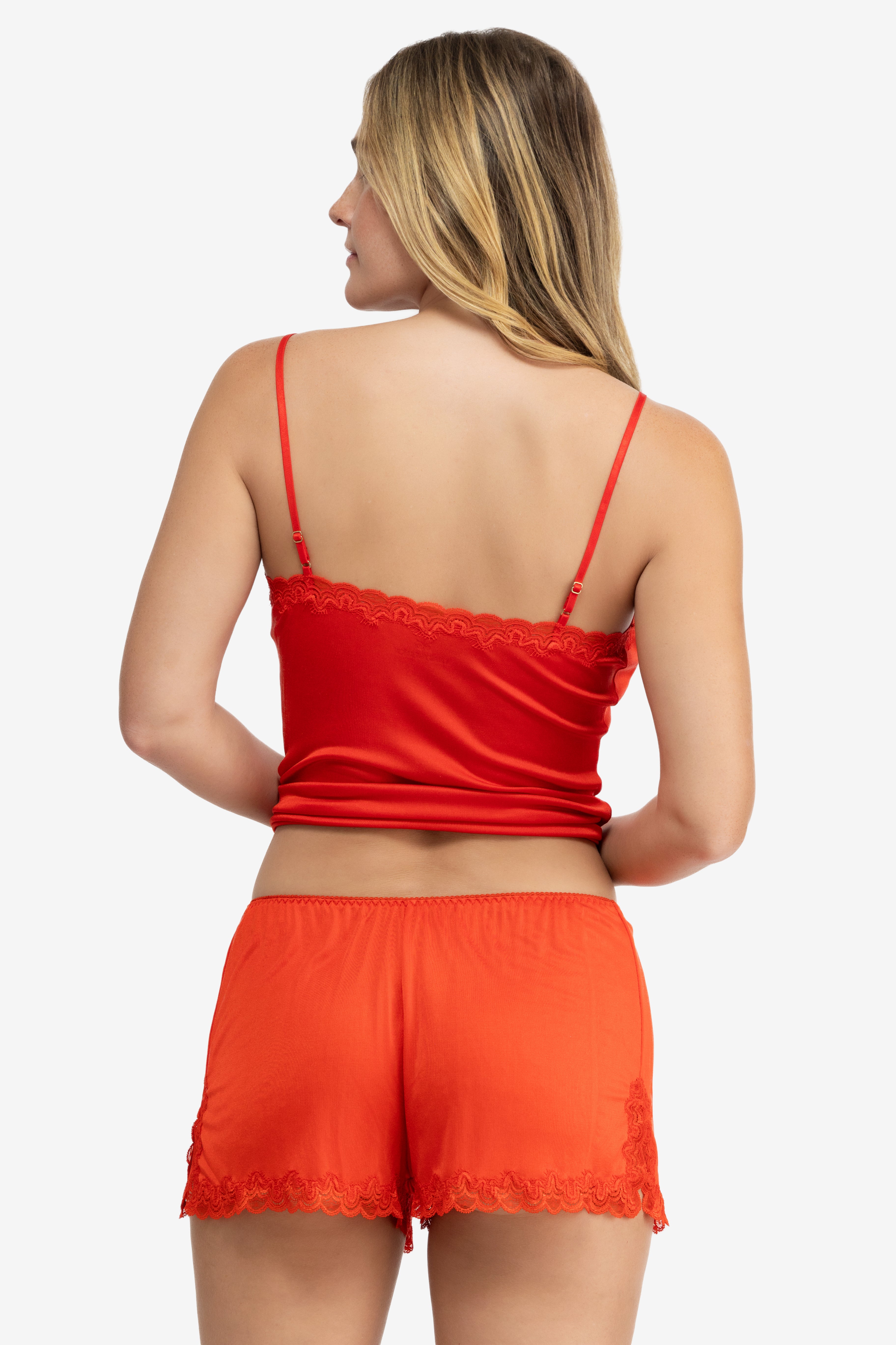 Model wearing Uwila Warrior Soft Silk Sleep Short in Fiery Red on White Background