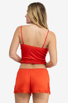 Model wearing Uwila Warrior Soft Silk Sleep Short in Fiery Red on White Background