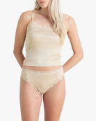 Model wearing Uwila Warrior Soft Silks Thong Underwear in Smoke Grey on White Background