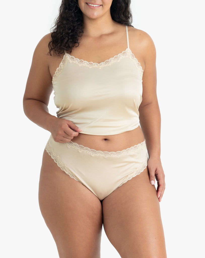 Model wearing Uwila Warrior Soft Silks Thong Underwear in Smoke Grey on White Background