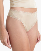 Model wearing Uwila Warrior Soft Silks Thong Underwear in Smoke Grey on White Background