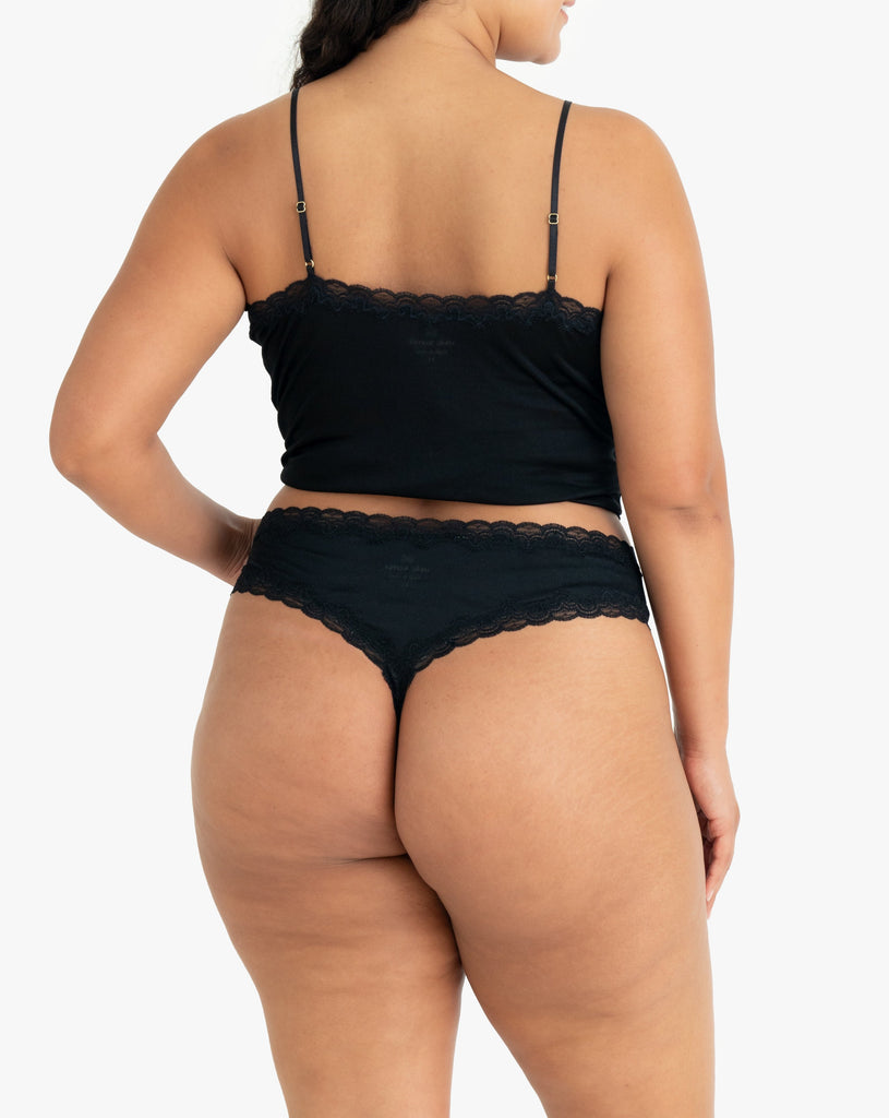 Model wearing Uwila Warrior Soft Silks Thong Underwear in Tap Shoe Black on White Background