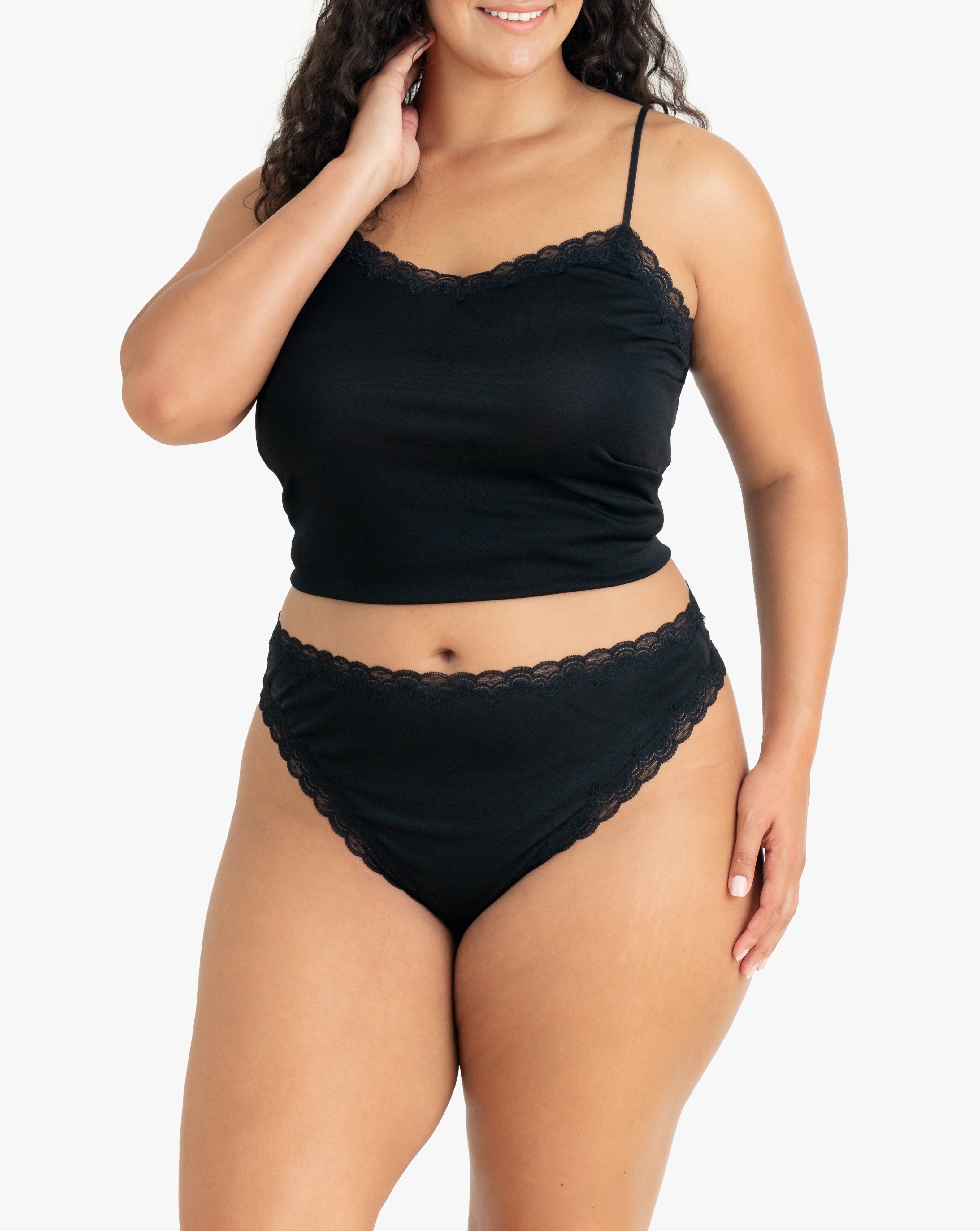 Model wearing Uwila Warrior Soft Silks Thong Underwear in Tap Shoe Black on White Background