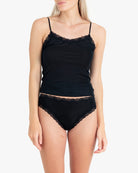 Model wearing Uwila Warrior Soft Silks Thong Underwear in Tap Shoe Black on White Background
