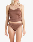 Model wearing Uwila Warrior Soft Silks Thong Underwear in Toffee on White Background