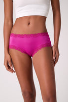 Model wearing Uwila Warrior Soft Silk Briefs in Festival Fuchsia