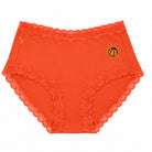 A pair of spicy orange soft silk briefs with a embroidered basketball patch on the upper right hip, displayed against a solid white background.