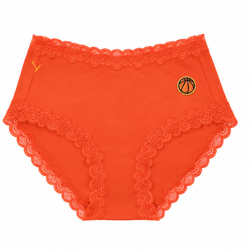A pair of spicy orange soft silk briefs with a embroidered basketball patch on the upper right hip, displayed against a solid white background.
