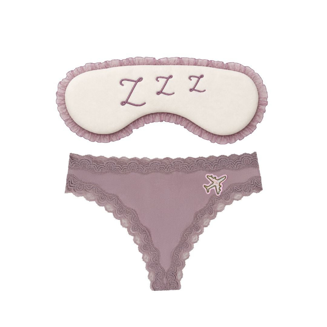 Flat Lay of the Uwila Warrior Sweet Dreams Travel Set featuring the Bon Voyage Silk Thong in Nirvana and the Sleep Mask. 