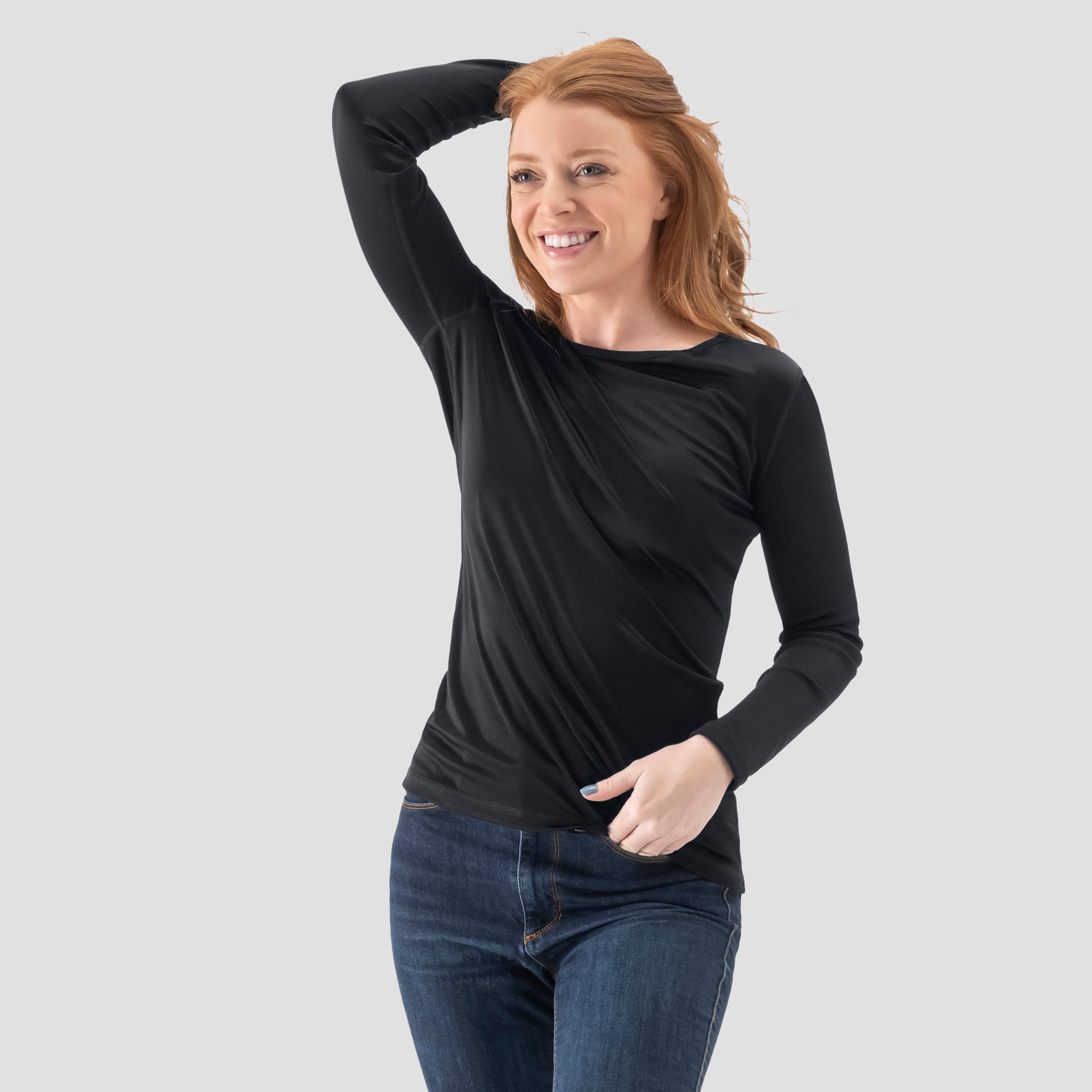 A model wearing a long-sleeve  Tap Shoe Black base layer T-shirt by Uwila Warrior, shown in a against a white background.