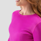 Model wearing A long-sleeve Hot Pink base layer T-shirt by Uwila Warrior, shown against a white background.