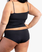 A woman wearing a tap shoe black soft seamless underwear briefs and cami set with lace details.