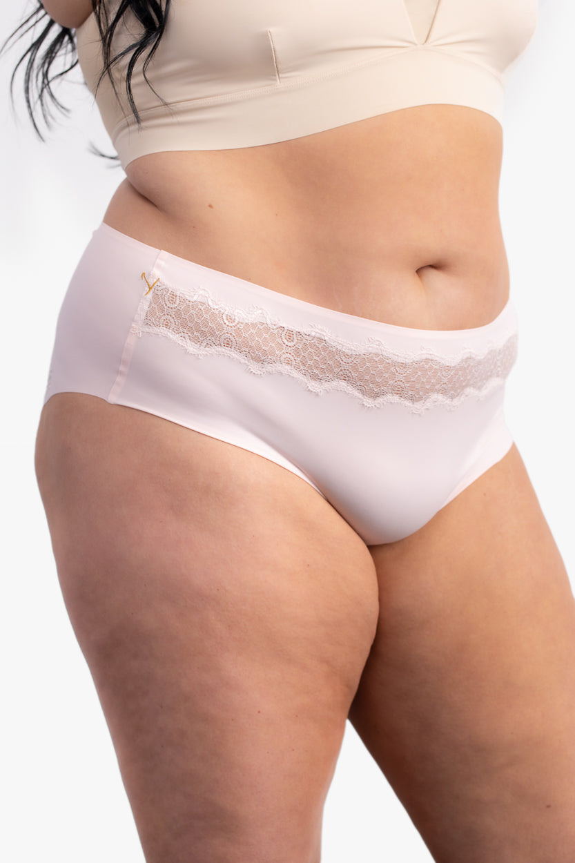 A pair of rose quartz soft seamless briefs with lace detailing white background.