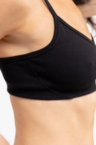 Model wearing a Tap Shoe Black bralette against a white background.